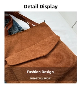 Close-up of brown corduroy tote bag featuring vertical texture and front pocket detail