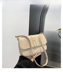 Dettaglio della borsa a tracolla in pelle kaki con elegante chiusura dorata rettangolare