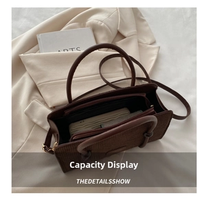 Detail view of brown corduroy tote bag showing spacious interior and secure zipper pocket