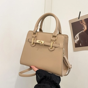 Beige faux leather Kelly handbag with adjustable shoulder strap and gold turn-lock closure