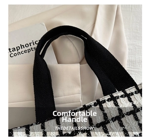 Detail of thickened fabric handle and black and white woven texture on the tote bag