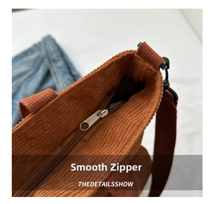 Detailed close-up of caramel corduroy tote texture and smooth metal zipper closure
