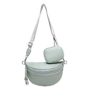 Mint green crescent crossbody bag with wide strap and round coin purse on white background