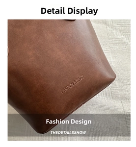 Detailed close-up of dark brown leather texture with Fashion & Bags embossed lettering