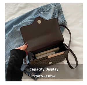 Brown monogram canvas bag interior showing large capacity for phone and accessories