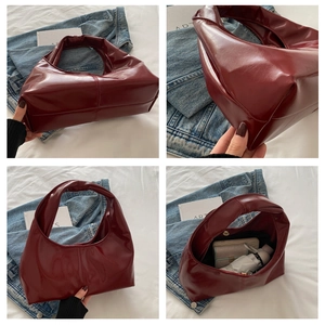 Detail view of large burgundy hobo bag showing spacious interior and wax leather texture
