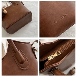 Detailed close-up of brown vintage leather texture and embossed Fashion & Bags logo