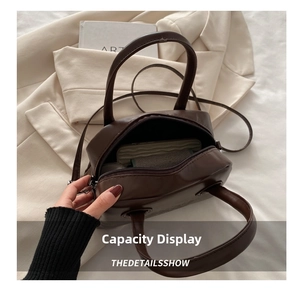Detail view showing spacious interior capacity of the dark brown matte boston bag