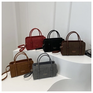 Group display of corduroy tote bags in five colors on a minimalist tiered stand