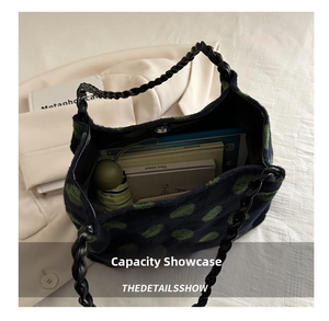 Détails de l'intérieur du grand sac en laine à pois verts et anse en cuir tressé