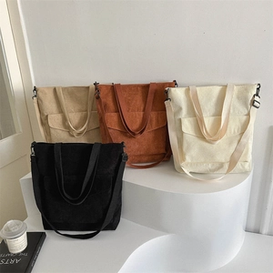 Four colors of minimalist corduroy tote bags with front pockets for daily commuting