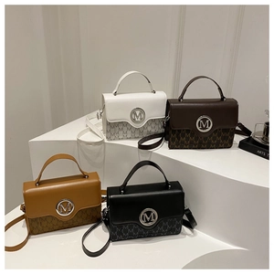 Detail view of retro square handbags with 'M' pattern in multiple color options