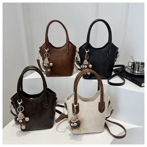 Minimalist matte PU leather tote bags in four colors with plush monkey charms on steps