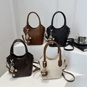 Contrast color bucket bag with plush monkey charm, large capacity crossbody handbag