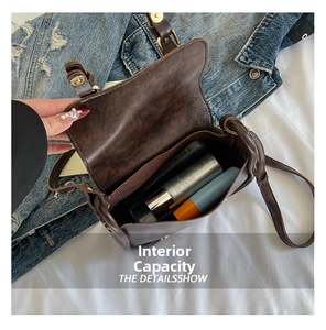 Macro view of the internal capacity of this vintage brown saddle bag with daily items