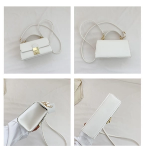 Detail view of white PU leather handbag featuring elegant gold metal twist lock and stitching