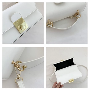 Detail view of white leather bag featuring gold metal clasp and premium stitching details