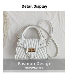 Close-up of ivory crossbody bag featuring V-quilted texture and gold metal turn-lock