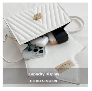 Internal capacity display of the white quilted crossbody bag with gold twist lock