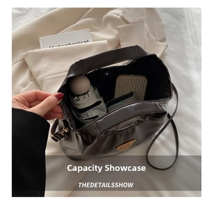 Interior view showing the large storage capacity of the dark leather bucket bag