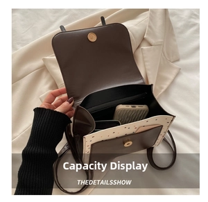 Interior view of polka dot crossbody bag showing capacity for phone and wallet