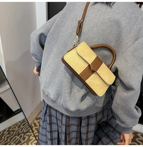 Retro contrast color crossbody bag with tan handles and beige leather paneling detail