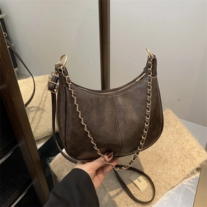 Retro dark brown crescent shoulder bag with gold chain and vertical stitching detail