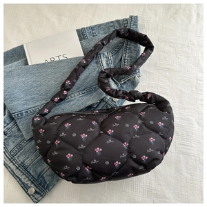 Close-up of black quilted canvas floral bag featuring pink flowers and Beautiful embroidery