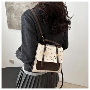 Close-up of retro backpack with polka dot print and Aimity 1985 text detail