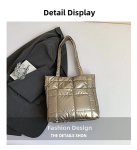 Detail of champagne gold quilted down tote bag with metallic snap button and large squares