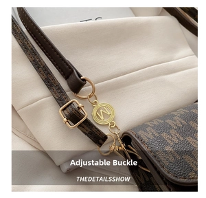 Detail of adjustable leather strap with golden hardware and luxury monogram pattern