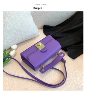 Detailed top view of a purple faux leather bag with gold lock on soft white faux fur