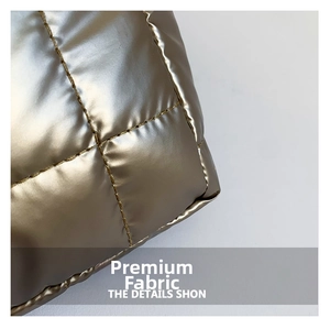 Macro shot of gold metallic quilted fabric with square stitching for padded tote bag