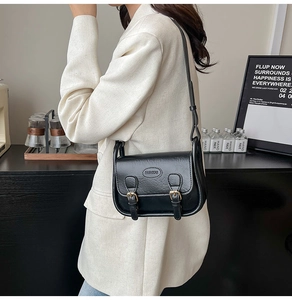 Black vintage square crossbody bag with textured leather and dual buckle decoration