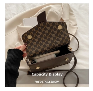 Interior view of the dark brown underarm bag showing capacity for phone and wallet