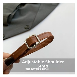 Macro view of adjustable brown leather strap with silver square buckle and stitching
