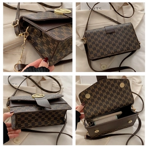Detail of brown monogrammed crossbody bag with golden M buckle and interior compartment