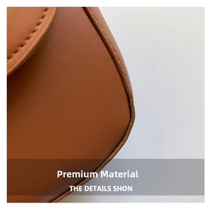 Close-up of premium brown grain leather texture with precise stitching and refined edges