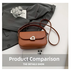 Detail view of brown shoulder bag with silver heart buckle and size scale with phone
