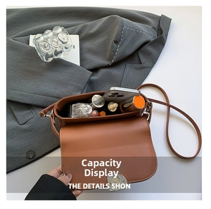Top view showing the spacious interior of the brown saddle bag with daily essentials