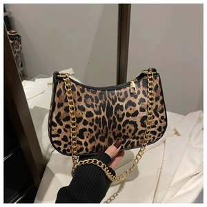 Detail of leopard print shoulder bag with gold chunky chain strap and zip closure