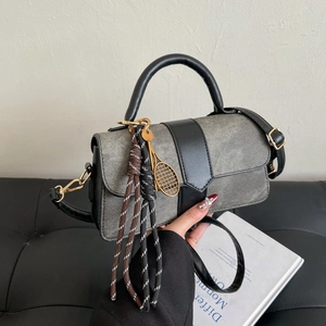 Gray denim and black leather handbag with golden tennis racket charm and strap