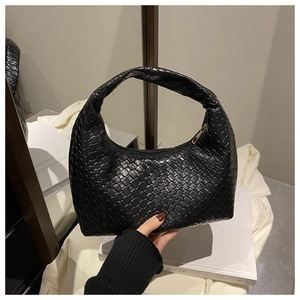 Close-up of black woven leather hobo bag showing detailed square texture and top handle