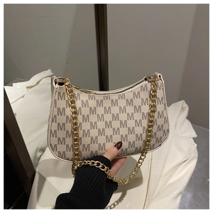 Detail of leopard print moon bag with golden chain strap and monogram patterns