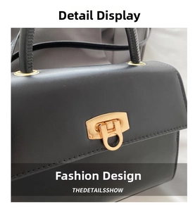 Detailansicht der schwarzen Lederhandtasche mit goldfarbenem rundem Metallverschluss
