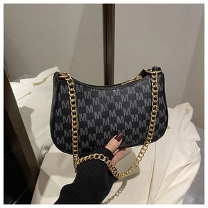 Detailed close-up of M-pattern jacquard shoulder bag with chunky gold chain strap