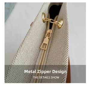 Close-up of golden hardware zipper and textured canvas fabric on the casual tote bag