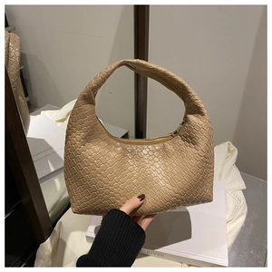 Close-up of beige woven hobo handbag featuring intricate Intrecciato leather texture