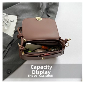 Detailed interior of mocha saddle bag with multiple compartments and a gold swivel lock