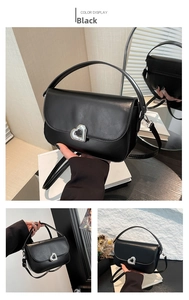 Detail of black PU leather saddle bag with silver heart-shaped metal twist lock closure
